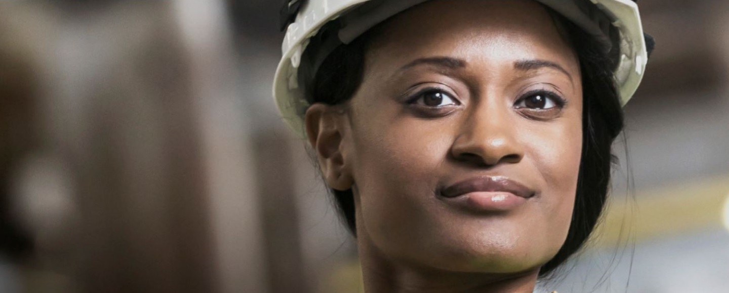 A profile of a woman wearing a hardhat