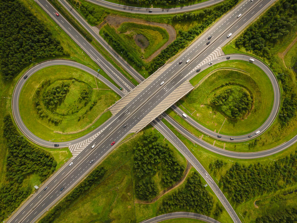 image of a motorway surrounded by green space