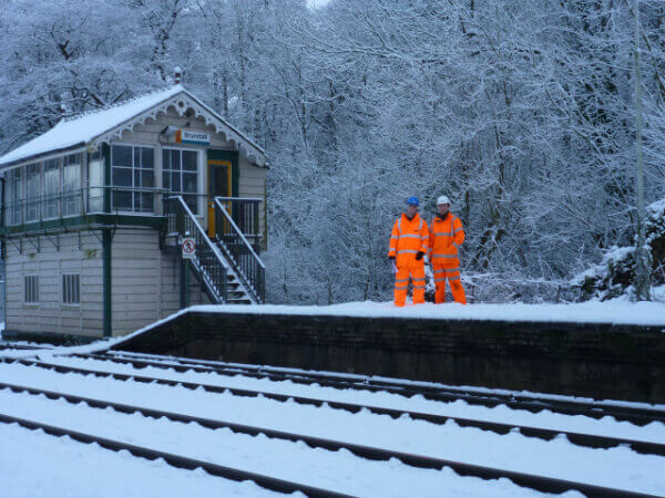 Ivan and his colleague working on the snowy rail track