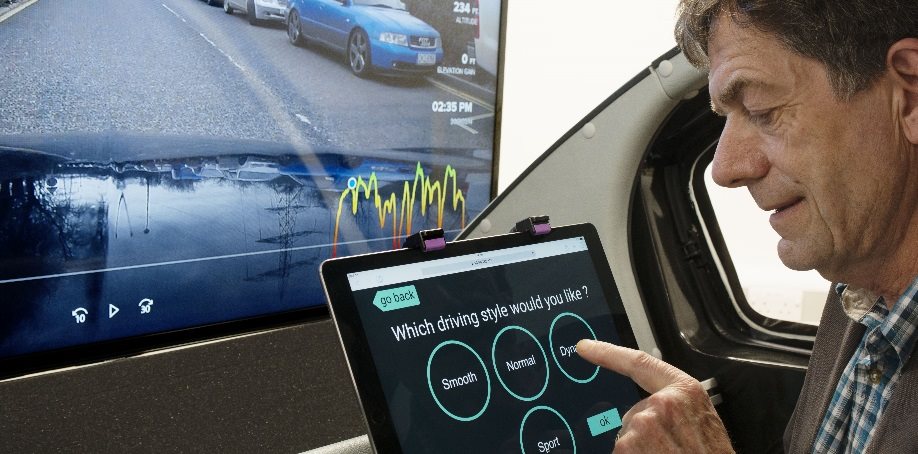 image of a hand selecting which driving style they would like in an autonomous vehicle