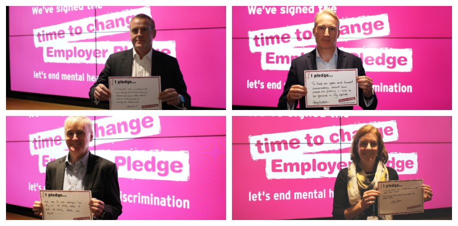 image of four employees holding i pledge signs